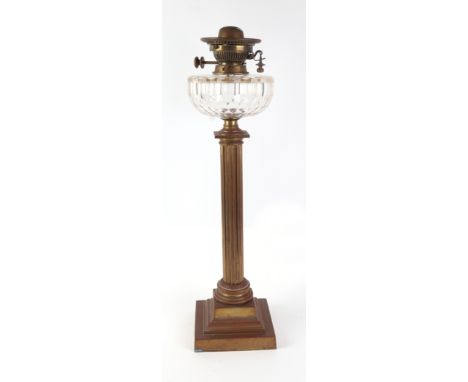 A Hinks No. 2 Duplex brass Corinthian column table oil lamp on a square stepped base with faceted clear glass reservoir, 60cm