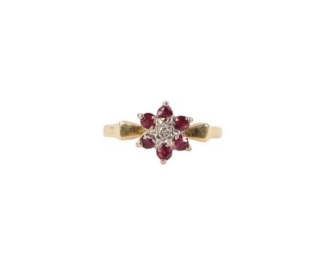 An 18ct gold ruby and diamond flowerhead ring, approx UK size I 1/2, 3.1g.