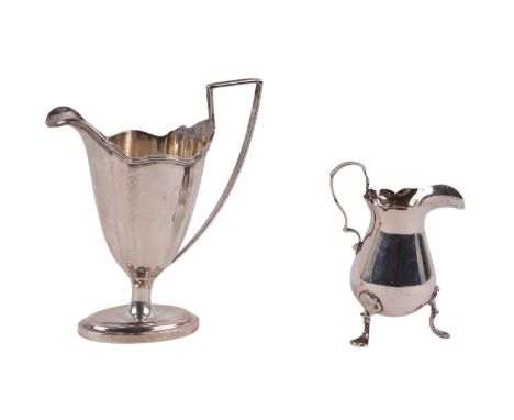 A silver helmet shaped milk jug, London 1897, engraved with a family crest, 13cms high; together with a silver cream jug, Bir