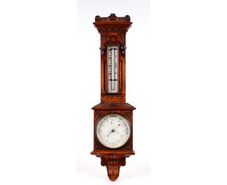 An Edwardian oak cased barometer thermometer, 63cms high.