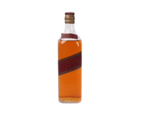 A sealed bottle of Jonnie Walker Red Label Old Scotch whisky, circa 1960.