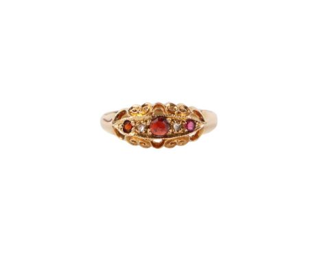 A late Victorian 18ct gold gypsy style ring with ruby and garnet stones, approx UK size N, 2.9g.