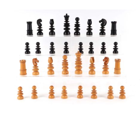 An antique boxwood and ebony chess set, king height 8.5cms, contained in a Victorian leather book form folding chess and back