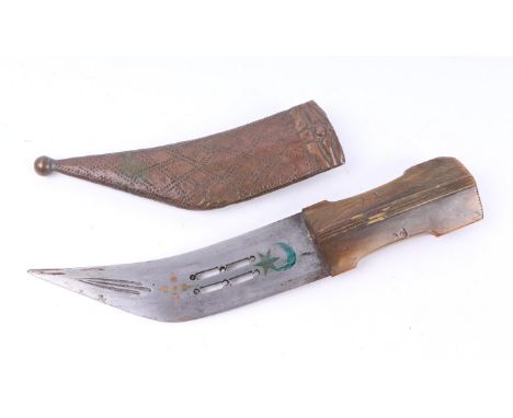 A Middle Eastern dagger with horn handle and copper mounted scabbard, 30cms long.