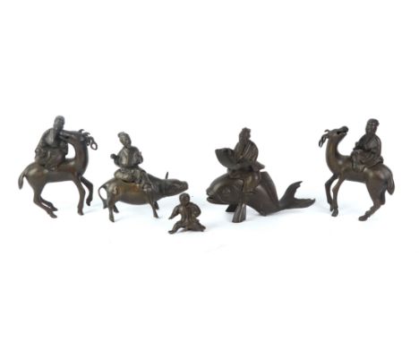 A group of Chinese silver and copper wire inlaid silver splash bronze figural censers depicting figures riding deer, oxen and