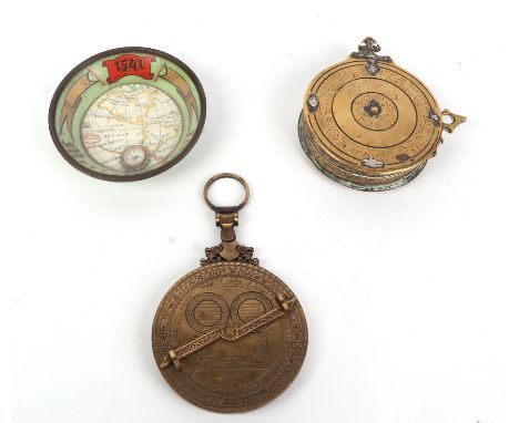 A Mercator World Map dish with inset compass and concave glass cover, 11.5cms diameter; together with a brass Astralobe, 10cm