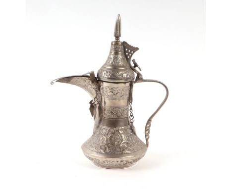 A Turkish / Islamic silver coloured metal dallah coffee pot, 29cms high.