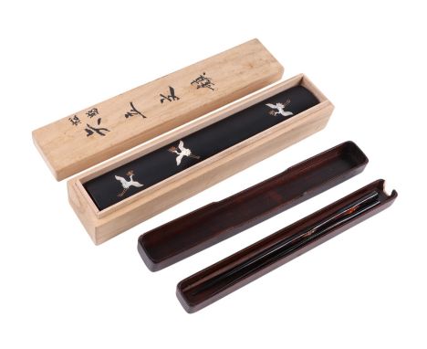 A Chinese black lacquer chopstick box and cover decorated with cranes in mother of pearl, 27cms long; together with another c