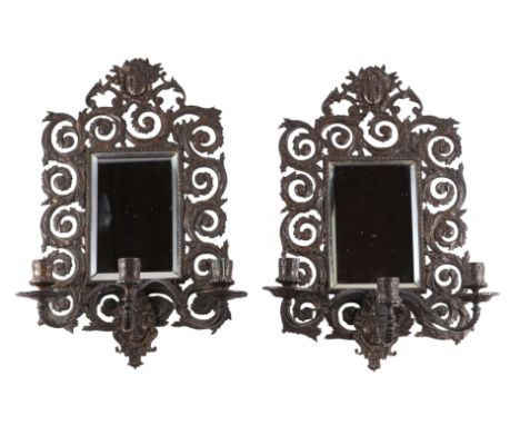 A pair of bronze mirror backed three-arm wall sconces, 27cms by 44cms (2).Condition ReportThe wax pans are missing to the fro