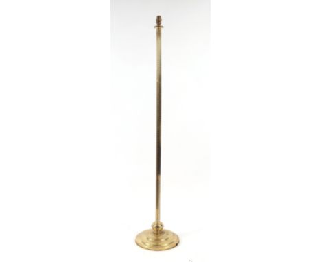 A brass standard lamp with hexagonal column on a circular stepped base, 130cms high.