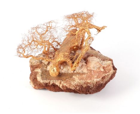 Patrick Drinkwater (1937-2024) - A golden tree sculpture of a fallen tree, the trunk of female form, her feet forming the roo
