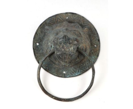 A patinated bronze lion mask door knocker, 16cms diameter.