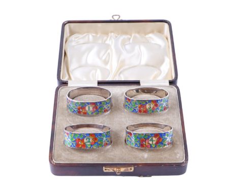 A boxed set of four silver and enamel napkin rings by Bernard Instone.Condition ReportNapkin one has enamel flakes to five le
