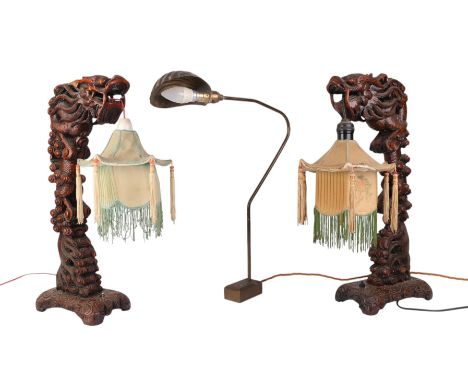 A pair of 1930's Chinese carved wooden dragon table lamps, 52cms high; together with a brass desk lamp (3).