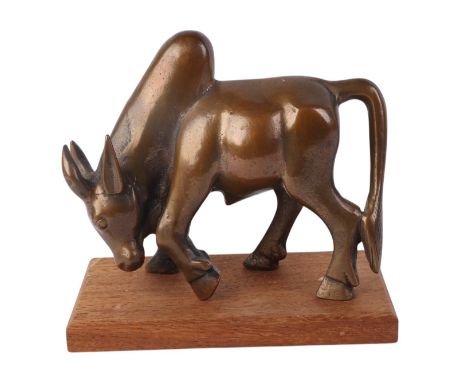 An Asian cast bronze model of an oxen on a wooden plinth, 21cms long.