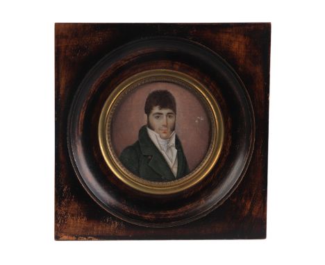 An early 19th century continental portrait miniature on ivory depicting a gentleman wearing a green coat, glazed and in a woo