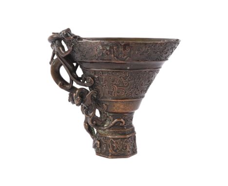 A Chinese bronze libation cup with applied chilong, 15cms high.