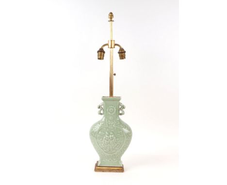 A Chinese moulded celadon glaze twin-handled vase with later gilt metal lamp fittings, the vase 27cms high.Condition ReportTh