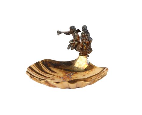 A silver gilt shell shaped dish with winged cherub decoration, London 1982, produced by Aurum to commemorate the birth of Pri