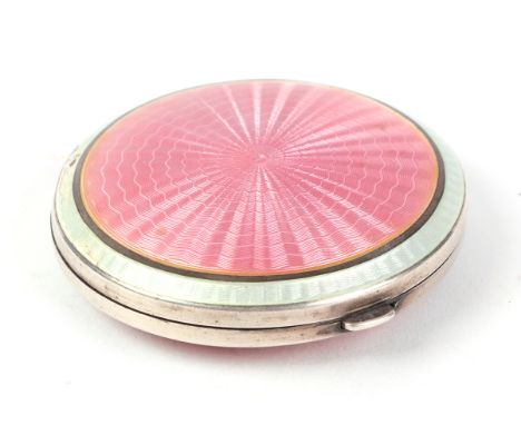 An Art Deco silver and pink guilloche enamel compact, Birmingham 1923, 5.5cms diameter, 63g.