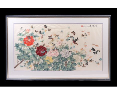 A large Chinese watercolour depicting flowers with a multitude of butterflies and calligraphy, framed & glazed, 144 by 55cms.