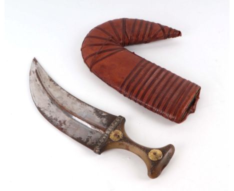 An Arab (possibly Yemen) jambiya dagger with horn handle and leather scabbard, 36cms long.