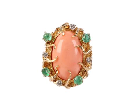 A 1960's 14ct gold naturalistic cocktail ring set with a large oval coral cabochon within a diamond and emerald border, attri
