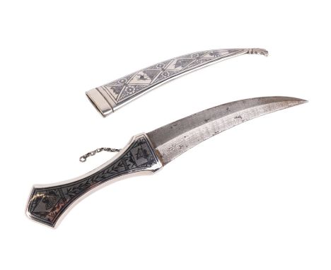 An Iraqi silver coloured metal dagger with niello decoration to the handle and scabbard, with 18cm curved steel blade.