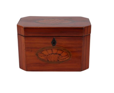 A 19th century tulip wood tea caddy of octagonal form with canted corners, inlaid with a shell to the top and front, later co