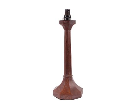A Christchurch Arts & Crafts oak lamp base in the manner of Arthur Romney Green with faceted column and base, 40cms high.Cond