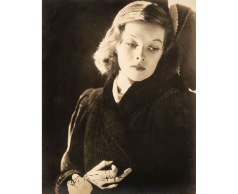 * Hepburn (Katherine, 1907-2003). A vintage signed atmospheric photograph of the young actress, half length in dark clothing,