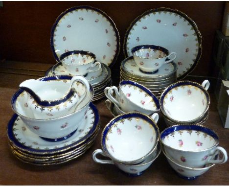 A Jackson & Gosling, Grosvenor tea service comprising two cake plates, twelve sandwich plates and saucers, milk jug, sugar bo
