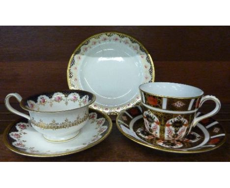 A Royal Crown Derby cup and saucer, 1128 pattern, and a Wedgwood trio, Y6578 mark on base