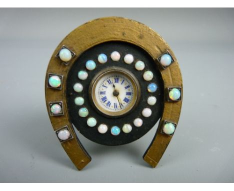 A MINIATURE BEDSIDE CLOCK set with twenty five opals, the enamel dial set with Roman numerals in blue, the movement with cres