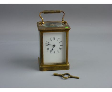 A HEAVY BRASS CARRIAGE CLOCK, late 19th/early 20th Century, white dial with Roman numerals, triple wind movement striking on 