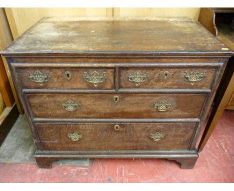 A 19th CENTURY EUROPEAN OAK CHEST of two short over two long drawers, oak lined with period and later pierced brass work, app