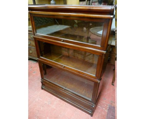 A GLOBE WERNICKE THREE STACK MAHOGANY BOOKCASE with shaped top and base section, 120 cms high, 87 cms wide