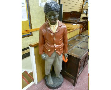 A 20th CENTURY COMPOSITION MODEL OF A LIFE SIZE STANDING PAPIER MACHE BLACK BOY on a circular base, 149 cms high