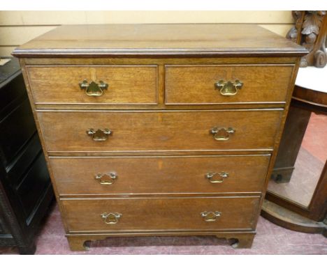 A 19th CENTURY OAK CHEST of two short over three long drawers, with cockbeaded edging, shaped brass backplates and swan neck 