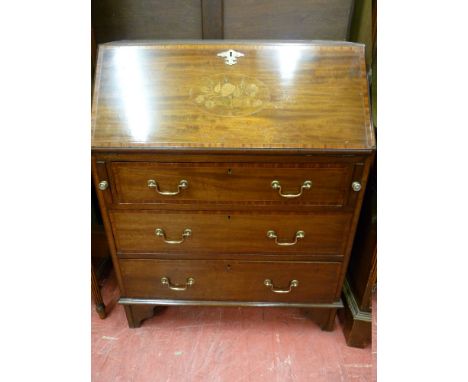 AN EDWARDIAN INLAID MAHOGANY FALL FRONT BUREAU with crossbanded edges and floral inlaid front cartouche, three lower drawers 