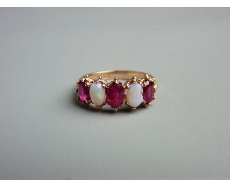 A FIFTEEN CARAT GOLD RUBY (three) & OPAL (two) DRESS RING, all oval cut stones, size 'O/P', 4.5 grms