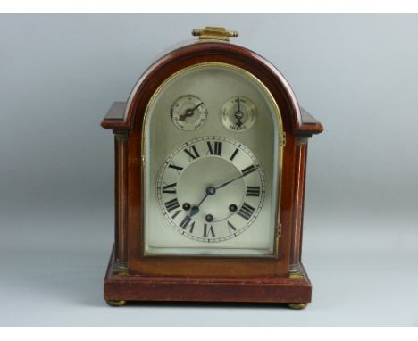 A MAHOGANY THREE TRAIN BRACKET CLOCK, the arched silvered dial set with Roman numerals, with slow/fast chime/silent subsidiar