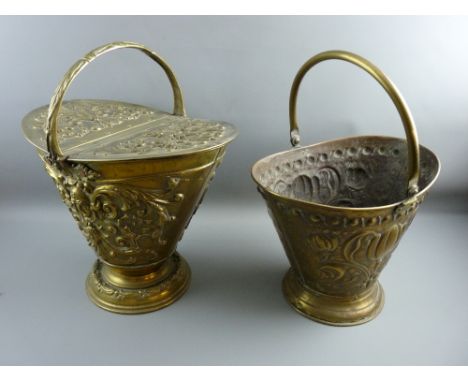 A TWIN LIDDED HELMET SHAPED REPOUSSE BRASS COAL SCUTTLE and one other, the former with date lozenge mark, 51 cms high overall