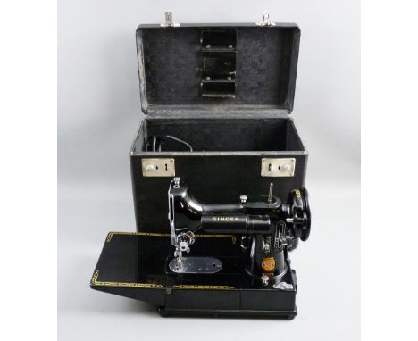 A CASED SINGER 222K SEWING MACHINE with foot pedal and a jar of attachments
