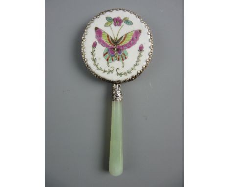 A SMALL ENAMELLED PORCELAIN BACKED CHINESE HAND MIRROR having a celadon jade handle, the porcelain in a white metal mount wit