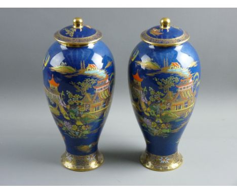 A PAIR OF CARLTONWARE BLUE ROYALE BALUSTER VASES with covers, with typical enamel and gilt chinoiserie decoration on a powder
