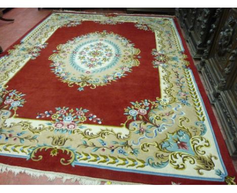 AN EXCELLENT LARGE HAND KNOTTED WOOLLEN CARPET, probably Indian with a central floral pattern cartouche and wide classically 