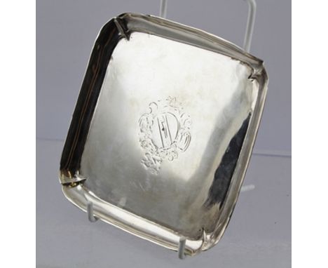 AN 18TH CENTURY SQUARE SILVER CARD TRAY, having raised rim on applied bracket feet, engraved armorial to sole, hallmarks cons