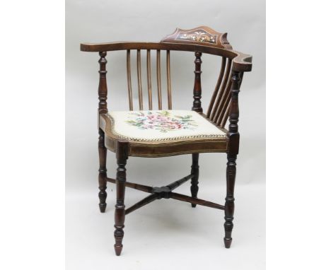 AN EDWARDIAN INLAID FRAMED CORNER CHAIR having woolwork seat of floral design, on ring turned supports and cross stretchers 