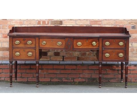 AN EARLY 19TH CENTURY MAHOGANY SIDEBOARD having panel back, arch breakfront with drawers, cellaret drawer to left, door to ri